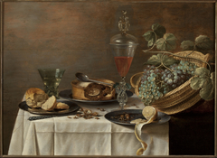 Still life with a wicker basket (Dessert). by Roelof Koets