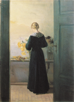 A young woman arranging flowers by Anna Ancher