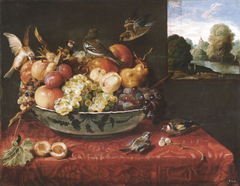 Still life with fruit bowl on a table and view of a landscape through an open window by Juan van der Hamen