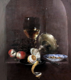 Still life with roemer, tazza, lemon and peaches in a niche by Willem Claesz Heda