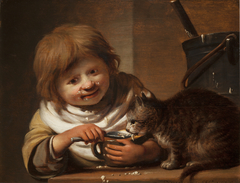 Boy feeding his Cat