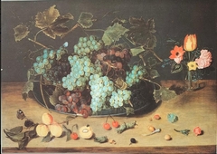 Glass of flowers and plate with grapes by Isaak Soreau