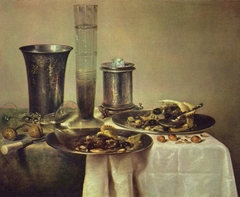 Still life with half-eaten pie, bier and silver cup on a table by Willem Claeszoon Heda