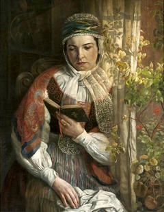 A woman in folk costume reading. by Zygmunt Sokołowski