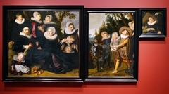 Portrait of a family in a landscape - left and right half together by Frans Hals