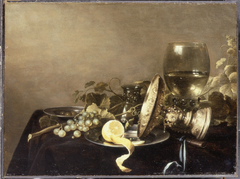 Still life with fruit and an overturned tazza before a roemer by Pieter Claesz