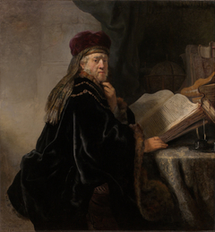 A Scholar, Seated at a Table with Books by Rembrandt