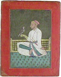 A Pahari raja seated on a terrace holding a hawk by Anonymous