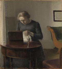 The Artist's Wife at a Sewing Table by Vilhelm Hammershøi