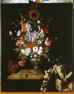 Still life with flowers in a vase, oriental carpet and a squirrel by Willem Frederiksz van Royen