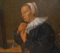 Woman seated at a tabel before a mirror (Dressing up) by Adriaen Brouwer